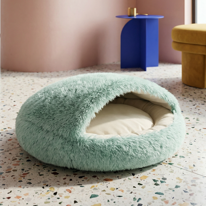 Mint green faux fur pet cave bed with a soft cream interior, designed for cozy hideaways.