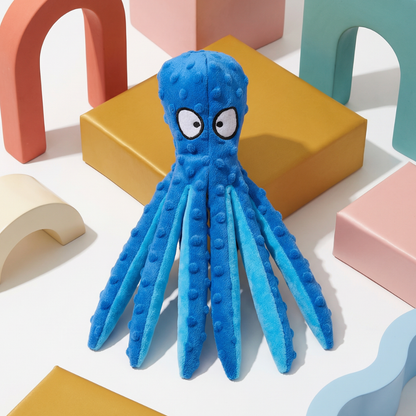 Blue plush octopus dog toy with white eyes, textured tentacles, on a white background with colorful blocks.